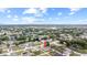 Aerial view of a charming neighborhood with a home surrounded by green landscapes and blue skies at 11123 Thornberry Dr, Spring Hill, FL 34609