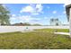 Spacious backyard with a white fence, grassy lawn, a grill and a stepping stone walkway at 11123 Thornberry Dr, Spring Hill, FL 34609