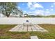 Backyard with a grill, a playhouse visible over the fence, and a stone patio at 11123 Thornberry Dr, Spring Hill, FL 34609