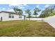 Fenced backyard offering a private space for outdoor activities, featuring a grill and grassy lawn at 11123 Thornberry Dr, Spring Hill, FL 34609