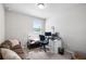 An office bedroom featuring a modern desk setup and a comfortable brown couch, ready for work or relaxation at 11123 Thornberry Dr, Spring Hill, FL 34609
