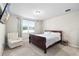 Comfortable bedroom featuring a queen bed, a window and an accent chair at 11123 Thornberry Dr, Spring Hill, FL 34609