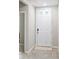 Clean entryway with a white door and neutral tile flooring at 11123 Thornberry Dr, Spring Hill, FL 34609