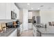Modern kitchen featuring white cabinets, granite countertops, and stainless steel appliances at 11123 Thornberry Dr, Spring Hill, FL 34609