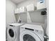 Functional laundry room with washer, dryer, shelving and storage at 11123 Thornberry Dr, Spring Hill, FL 34609
