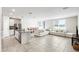 Bright open-concept living room featuring tile floors, ample seating, and seamless flow to the dining area at 11123 Thornberry Dr, Spring Hill, FL 34609