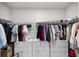 Organized walk-in closet with hanging clothes and storage drawers, maximizing space and style at 11123 Thornberry Dr, Spring Hill, FL 34609