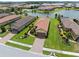 Aerial view of a home with a tile roof, surrounded by manicured lawns and landscaping in a residential community at 11354 Callisia Dr, Odessa, FL 33556