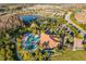 Aerial view of the community amenities including pool, clubhouse, tennis courts, and scenic lakes, offering a vibrant lifestyle at 11354 Callisia Dr, Odessa, FL 33556