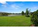 Expansive backyard overlooking a serene lake view and lush green landscaping, perfect for outdoor relaxation at 11354 Callisia Dr, Odessa, FL 33556