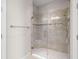Modern glass shower with tile surround, including a convenient built-in seat, in a well-lit bathroom at 11354 Callisia Dr, Odessa, FL 33556