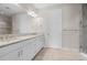 Modern bathroom with double vanity, granite countertops, tile flooring, and access to glass enclosed shower at 11354 Callisia Dr, Odessa, FL 33556