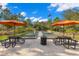Well-maintained bocce ball court with picnic tables and umbrellas, perfect for outdoor games and social gatherings at 11354 Callisia Dr, Odessa, FL 33556