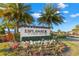 Beautiful community entrance sign surrounded by colorful flowers and lush landscaping at 11354 Callisia Dr, Odessa, FL 33556