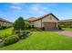Beautiful home featuring a well-maintained lawn, lush landscaping, and a two-car garage at 11354 Callisia Dr, Odessa, FL 33556