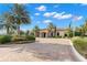 Elegant home featuring a circular driveway, lush landscaping, and a tile roof at 11354 Callisia Dr, Odessa, FL 33556