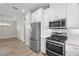 Bright kitchen features stainless steel appliances, white cabinets, and granite countertops at 11354 Callisia Dr, Odessa, FL 33556
