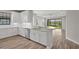 Beautiful kitchen with white cabinets, stainless steel appliances, and a view of the backyard pond at 11354 Callisia Dr, Odessa, FL 33556