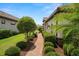 Beautifully landscaped walkway with lush greenery and manicured bushes leading to the side of the house at 11354 Callisia Dr, Odessa, FL 33556