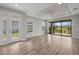 Spacious living room with tray ceiling, lots of natural light, and a view of the serene backyard pond at 11354 Callisia Dr, Odessa, FL 33556