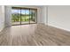 Bright room with a view of a pond through sliding glass doors and light wood-look floors at 11354 Callisia Dr, Odessa, FL 33556