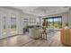 Bright living room with ample seating, stylish decor, and a view of the serene backyard pond at 11354 Callisia Dr, Odessa, FL 33556