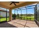 Screened patio with brick flooring and views of the backyard pond and landscaping at 11354 Callisia Dr, Odessa, FL 33556