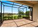 Screened patio with brick flooring and views of the backyard pond and landscaping at 11354 Callisia Dr, Odessa, FL 33556