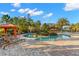 Stunning community pool with lounge chairs and cabanas surrounded by tropical landscaping for ultimate relaxation at 11354 Callisia Dr, Odessa, FL 33556