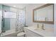 Updated bathroom with scallop-tile accent wall in shower and shaker-style vanity at 11720 80Th Ave, Seminole, FL 33772