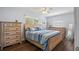 Bright bedroom featuring a wood-framed bed, wooden dresser, and windows with wood blinds at 11720 80Th Ave, Seminole, FL 33772