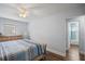 Bedroom featuring natural-wood framed bed and an open ensuite bathroom with updated tile at 11720 80Th Ave, Seminole, FL 33772