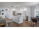 Modern white kitchen featuring stainless steel appliances, quartz countertops, and a central island at 11720 80Th Ave, Seminole, FL 33772