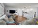 Open-concept living room with a large sectional sofa, TV, and kitchen with a center island at 11720 80Th Ave, Seminole, FL 33772