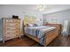 Comfortable bedroom featuring a wooden bed frame, matching dressers, and dark wood floors at 11720 80Th Ave, Seminole, FL 33772