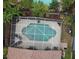 Aerial view of a screened-in pool surrounded by lush landscaping and a well-maintained yard at 11821 Easthampton Dr, Tampa, FL 33626