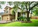Charming two-story home featuring lush landscaping, an attached two-car garage, and manicured front yard at 11821 Easthampton Dr, Tampa, FL 33626