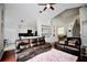 Inviting living room with leather couches, open layout to the kitchen, and staircase access at 11821 Easthampton Dr, Tampa, FL 33626