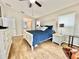 This main bedroom has wood flooring, a ceiling fan, and a white dresser at 11821 Easthampton Dr, Tampa, FL 33626
