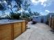Backyard area featuring a hot tub, patio, dining table, and fenced perimeter at 1200 47Th St N, St Petersburg, FL 33713