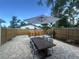 Inviting backyard with a dining table and an umbrella for outdoor dining and relaxation at 1200 47Th St N, St Petersburg, FL 33713