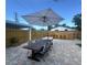 Outdoor dining area with a large table, chairs, shade umbrella and outdoor bar at 1200 47Th St N, St Petersburg, FL 33713