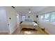 Bright bedroom featuring light hardwood floors, a ceiling fan, and a large window at 1200 47Th St N, St Petersburg, FL 33713