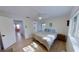 Bright bedroom featuring light hardwood floors, a ceiling fan, and ensuite bathroom at 1200 47Th St N, St Petersburg, FL 33713