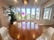 Bright dining room with a round table, white chairs, and a large window overlooking the neighborhood at 1200 47Th St N, St Petersburg, FL 33713