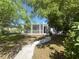 Quaint home featuring a covered front porch and landscaped garden at 1200 47Th St N, St Petersburg, FL 33713