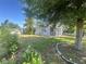 Charming home with lush landscaping, a white picket fence, and mature trees at 1200 47Th St N, St Petersburg, FL 33713