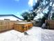 Backyard with a wooden hot tub surrounded by wooden privacy fence with outdoor stools for seating at 1200 47Th St N, St Petersburg, FL 33713
