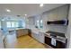 Modern kitchen with gray cabinets, quartz countertops, and stainless steel appliances at 1200 47Th St N, St Petersburg, FL 33713