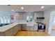 Bright kitchen with stainless appliances, light gray cabinets, and a farmhouse sink beneath a window at 1200 47Th St N, St Petersburg, FL 33713